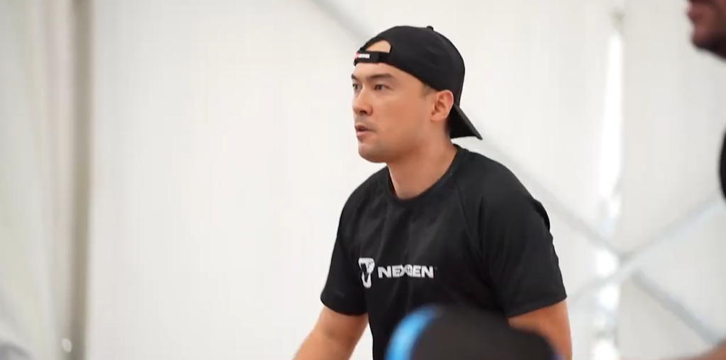 VIDEO HIGHLIGHTS | AMORAP Pickleball Tournament 2026 Photo is a person with a black tshirt playing pickle ball.